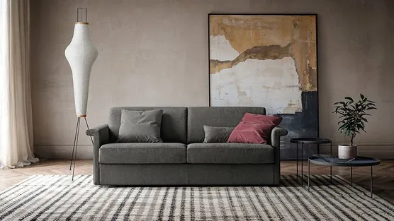 divano letto grigio con bracciolo sagomato 